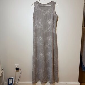 Linen maxi dress sleeveless with all over embroidery smocking detail for shape.